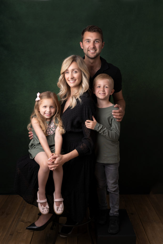 Family with two children, dressed in green photographed by Newborn Photographer in Lichfield staffordshire